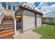 Backyard view showing covered outdoor bar, a hot tub, and stairs to the second floor at 13027 Beacon Ct, Hudson, FL 34667