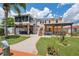 Well-maintained backyard with a pergola, lawn, outdoor seating area and access stairs at 13027 Beacon Ct, Hudson, FL 34667