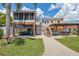 Expansive backyard featuring a pergola, screened patio, lush lawn, and outdoor seating area, perfect for entertaining at 13027 Beacon Ct, Hudson, FL 34667
