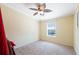 Cozy bedroom with a ceiling fan and a window offering a waterfront view at 13027 Beacon Ct, Hudson, FL 34667