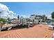 Boat dock featuring multiple boat mooring locations and modern boat lifts on a sunny day with blue skies at 13027 Beacon Ct, Hudson, FL 34667