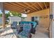 Covered outdoor patio with tile flooring, comfortable seating, and a ceiling fan at 13027 Beacon Ct, Hudson, FL 34667