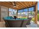 Comfortable covered outdoor patio features a sectional sofa and two chairs facing the canal with boats docked nearby at 13027 Beacon Ct, Hudson, FL 34667