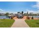 Beautiful waterfront dock featuring lush landscaping and a boat, perfect for relaxation at 13027 Beacon Ct, Hudson, FL 34667
