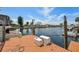 Wooden dock with boat mooring and storage containers on a sunny day at 13027 Beacon Ct, Hudson, FL 34667