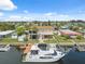 Two-story waterfront home featuring a private dock, lush backyard, and boat, perfect for canal living at 13027 Beacon Ct, Hudson, FL 34667