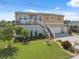 Charming two-story home with landscaped front yard, garage, and inviting stairway at 13027 Beacon Ct, Hudson, FL 34667