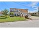 Two-story home with manicured lawn, a staircase to the raised porch, and an attached garage at 13027 Beacon Ct, Hudson, FL 34667