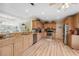 Bright kitchen with granite countertops, stainless steel appliances, and wood-look flooring at 13027 Beacon Ct, Hudson, FL 34667