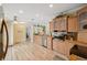 Bright kitchen with granite countertops, stainless steel appliances, and wood-look flooring at 13027 Beacon Ct, Hudson, FL 34667