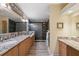 Elegant bathroom with dual sinks, granite countertops, and a luxurious walk-in shower at 13027 Beacon Ct, Hudson, FL 34667
