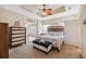 Comfortable main bedroom featuring a ceiling fan and decorative coastal accents at 13027 Beacon Ct, Hudson, FL 34667