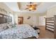 Main bedroom with a view of the shower, decorative coastal theme, and ceiling fan at 13027 Beacon Ct, Hudson, FL 34667