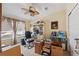 Functional home office with a ceiling fan, built-in shelving, and a bright window at 13027 Beacon Ct, Hudson, FL 34667