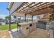 Covered patio includes outdoor kitchen bar with mini fridge, a hot tub, and great water views with boat dock access at 13027 Beacon Ct, Hudson, FL 34667