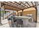 Outdoor living featuring a covered kitchen, complete with bar seating and a hot tub, easily accessible from the stairs at 13027 Beacon Ct, Hudson, FL 34667