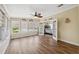 Bright sun room featuring wood floors, windows, and access to the bedroom at 13027 Beacon Ct, Hudson, FL 34667