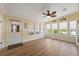 Sun room with wood floors, a ceiling fan, and views of the outdoors at 13027 Beacon Ct, Hudson, FL 34667