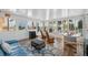 Bright sunroom featuring waterfront views, a seating area, and wood-look floors at 13027 Beacon Ct, Hudson, FL 34667