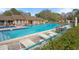 Exterior shot of the outdoor community pool with lounge chairs and seating areas for residents at 13134 Cypress Hill Dr, Hudson, FL 34669