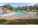 Relax by the large outdoor community pool with plenty of seating and lounging options at 13134 Cypress Hill Dr, Hudson, FL 34669