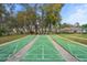 Community shuffleboard courts with covered benches in an active 55+ community at 13134 Cypress Hill Dr, Hudson, FL 34669