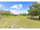 Large fenced backyard featuring ample open space, mature trees, and a storage shed at 13180 Montour St, Brooksville, FL 34613
