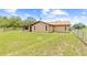 Backyard of home with chain-link fencing and green grass at 13180 Montour St, Brooksville, FL 34613