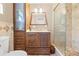 Bathroom includes tiled shower, marble countertops and wood cabinet at 13180 Montour St, Brooksville, FL 34613