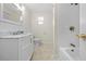 Clean white bathroom featuring vanity, tiled tub-shower combo, and tiled floor at 13180 Montour St, Brooksville, FL 34613
