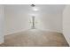 Spacious bedroom with plush carpet, a ceiling fan, and a window with curtain accents at 13180 Montour St, Brooksville, FL 34613