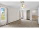 Well-lit bedroom with two windows, neutral walls, soft carpet, and open closet and doorway at 13180 Montour St, Brooksville, FL 34613
