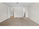 Bright bedroom with soft carpet, neutral walls, and a closet and doorway to another room at 13180 Montour St, Brooksville, FL 34613