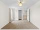 Bright bedroom with soft carpet, neutral walls, and a closet and doorway to another room at 13180 Montour St, Brooksville, FL 34613