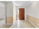 Inviting entryway with tiled floor, wood door and a glimpse into another room at 13180 Montour St, Brooksville, FL 34613