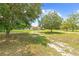 Scenic view of a charming single story home with a long driveway and mature trees at 13180 Montour St, Brooksville, FL 34613