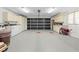 Spacious garage with neutral cabinets, laundry, generator, and dark grey door at 13180 Montour St, Brooksville, FL 34613