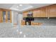 Granite countertops and stainless steel appliances enhance this well-lit kitchen at 13180 Montour St, Brooksville, FL 34613