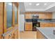 Well-lit kitchen features wood cabinets, stainless steel microwave, and black range at 13180 Montour St, Brooksville, FL 34613