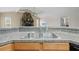 Kitchen sink with a view of the stone fireplace in the living area at 13180 Montour St, Brooksville, FL 34613