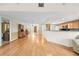 Inviting living space featuring hardwood floors, a breakfast bar, and views of the entry and kitchen at 13180 Montour St, Brooksville, FL 34613