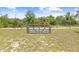 View of the rear pasture featuring wood fencing and a metal gate at 13180 Montour St, Brooksville, FL 34613