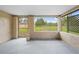 Sunroom overlooking expansive yard with utility shed and fencing at 13180 Montour St, Brooksville, FL 34613
