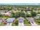 Picture of the blue house surrounded by lush trees and manicured lawns in a tranquil community at 13321 Norman Cir, Hudson, FL 34669