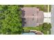 An aerial view captures the roof and surrounding landscaping of a well-maintained home at 13321 Norman Cir, Hudson, FL 34669