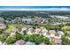 An aerial view showcases homes in a beautiful neighborhood surrounded by a golf course and trees at 13321 Norman Cir, Hudson, FL 34669