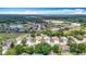 An aerial view showcases homes in a beautiful neighborhood surrounded by a golf course and trees at 13321 Norman Cir, Hudson, FL 34669
