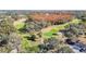 Scenic aerial view of the golf course and surrounding wooded area at 13321 Norman Cir, Hudson, FL 34669