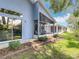 The lush backyard features an enclosed screened patio, offering a serene outdoor retreat at 13321 Norman Cir, Hudson, FL 34669