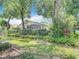 A lush backyard is featured with mature trees and garden space providing a private oasis at 13321 Norman Cir, Hudson, FL 34669